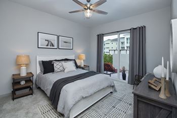 Bedroom with carpeting and large window